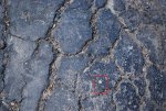 cracked_asphalt_texture_by_mythirll-d5kit96.jpg